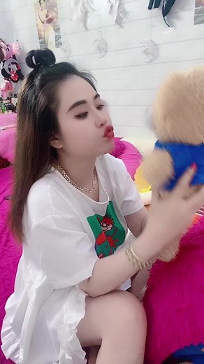 Young Woman's Charming Teddy Bear Interaction