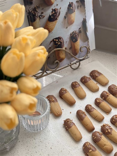 Ina Garten’s - Chocolate Dipped Brown Sugar cookies 🤎 From her book - modern comfort Ingredients 3/4 pound (3 sticks) unsalted butter, at room temperature 1 cup light brown sugar, lightly packed 2 teaspoons pure vanilla extract 3 cups all-purpose flour 1 teaspoon kosher salt For the chocolate coating: 1 cup milk chocolate morsels, such as Hershey’s (6 ounces) 6 tablespoons (3/4 stick) unsalted butter 1/2 cup toasted pecans, minced and lightly salted Directions Preheat the oven to 350 degrees F.