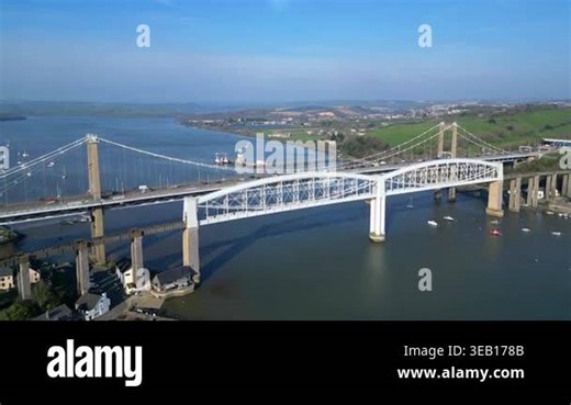 Saltash, Cornwall, England: DRONE VIEWS: The Tamar bridge (road) and the Royal Albert Bridge (rail) spanning the River Tamar. The River Tamar divides the counties of Devon and Cornwall, both of which are popular UK holiday destinations (Clip 8 Stock Video Footage - Alamy