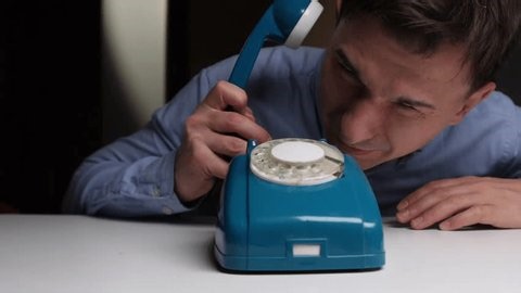 clip-3964402637-detective-studies-blackphone-man-observes-vintage-rotary