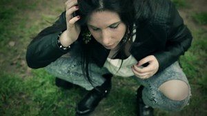 detail of sick young woman vomiting on the grass