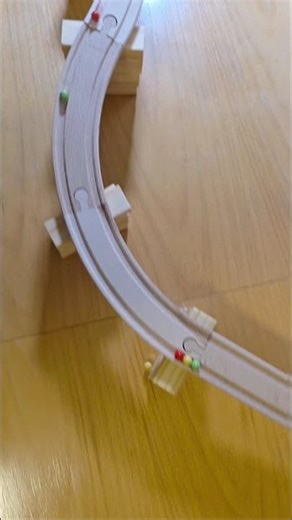 Colorful Small Beads Rolling on a Wooden Marble Run