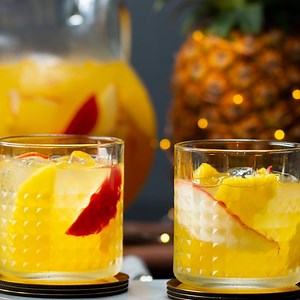 A holiday spin on the classic Peruvian cocktail. Red pear and pineapple slices garnish this slightly sweet and super fruity drink, lending a little holiday color and seasonal flavor! | Tasty