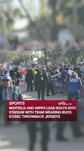 Baker Mayfield and Tristan Wirfs lead the Bolts into Raymond James Stadium with the Bolts wearing the Bucs iconic creamsicle jerseys. https://www.wfla.com/sports/nhl/everything-you-need-to-know-before-2026-nhl-stadium-series/ | WFLA News Channel 8