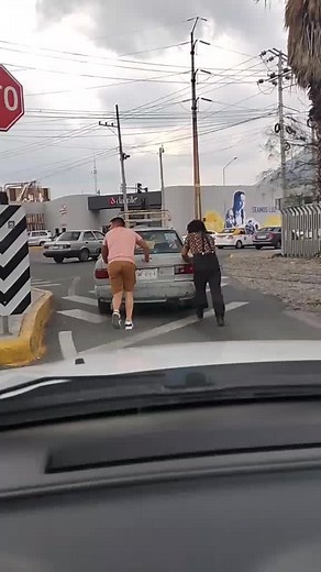 Urban Car Push Challenge: Man and Woman Team Up
