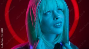 Woman in futuristic costume. Female in modern VR glasses interacting with network while having virtual reality experience. Augmented reality game, future technology.