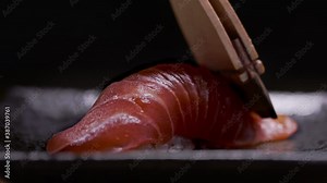 Tuna brushed. Authentic Japanese sushi is prepared by an expert chef. Shot in 4k.