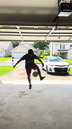Soccer Tricks Performed in a Sunlit Suburban Garage