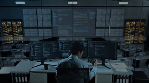 clip-1110064727-back-view-asian-man-developer-working-mobile