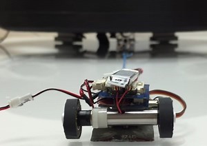 Watch These Tiny Robots Move a 2 Ton Car