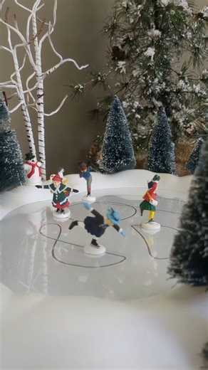 Glide into the Magic! Our Animated Skating Pond brings your Village to life with four charming skaters twirling around a tree-lined rink. It even includes its own power adapter for easy setup! https://bit.ly/47YFlpP | Department 56