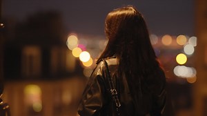 Beautiful woman at night in paris, france with bokeh lights backdrop Premium Stock Video Footage