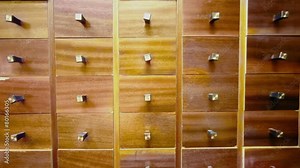 Hand opens compartment in cabinet and takes cd disk from it, then close