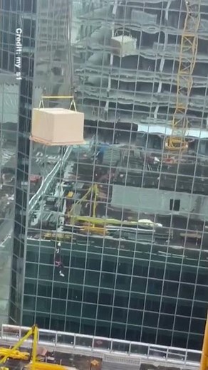 WATCH: Man dangling from construction crane