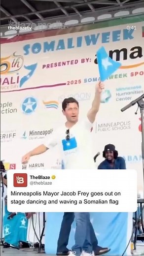 Minneapolis Mayor Jacob Frey cringe dancing on stage waving the Somalian flag during Somaliweek.