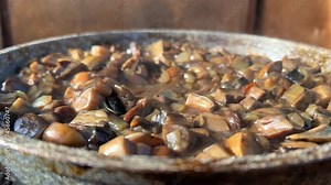 Cooking porcini mushrooms in a frying pan. Fry the porcini mushrooms in a frying pan, stirring. The blueberries are fried in a frying pan. Mushroom stewing. Processing of redheads.