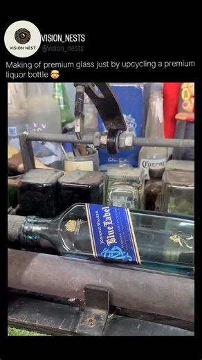 Vision nest on Instagram: "the craftsmanship behind upcycling a premium liquor bottle—specifically a Johnnie Walker Blue Label bottle—into a custom piece of glassware. The process begins with scoring, where the bottle is placed on a specialized cutting jig and rotated against a diamond-tipped blade to create a clean, etched line around the circumference. To achieve a perfect break without shattering the bottle, the creator employs the thermal shock technique, alternating between extreme heat (bo