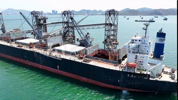 Aerial top view wood chips load chip from silo to cargo ship vessel concept green fuel for save earth. renewable energy from wood Chips