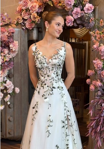 Meet “Fiona” - shades of green combine in ivy lace, alongside ivory flowers, trickling down a soft tulle skirt. Which detail is your favorite in this dimensional wedding gown? #weddingdress #floralweddingdress #colorfulweddingdress #avalaurennebride #bride