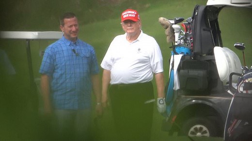 Trump wears his signature MAGA hat while golfing in Florida