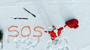 Screaming Santa Claus, skis and a SOS sign