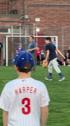 Children are playing ball in the field.