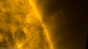 A solar prominence hovers over the Sun