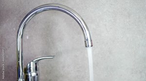 water pouring from a faucet tap slow motion