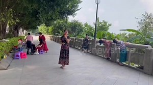 Stone bridge handrail snaps as woman uses it for stretching exercise