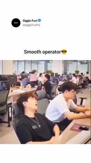 Giggle Fuel on Instagram: "A young man is sitting in a busy office, leaning back in his chair with his eyes closed, appearing to be asleep or very relaxed. A female colleague walks up to him and stands nearby, looking toward him. Suddenly, he sits up and starts typing quickly on his keyboard as if he were working hard the whole time. He even gives a subtle thumbs-up to a coworker sitting next to him while he continues to type, pretending to be fully focused on his tasks to avoid getting in troub