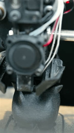 clip-3970022645-3d-printer-creating-black-plastic-detailed-object