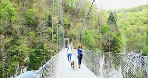 Young couple hiking in the Basque Country near the Holzarte footbridge
