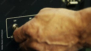 Projectionist Hand Switching Off and On Movie Projector at Cinema. Close-Up. 4K Resolution.