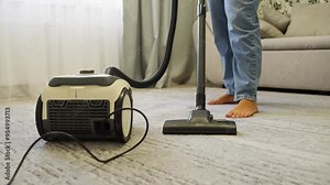 Cleaning at home, the girl vacuums the floor. A woman cleans with a vacuum cleaner. High quality 4k footage