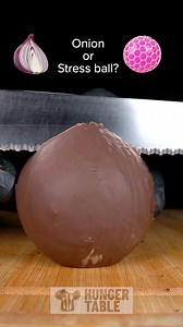 4.5M views · 873 reactions | Everyone saying it’s a stress ball… Nah mate. Watch to the end. You won’t believe what’s inside. #OnionOrStressBall #FoodPrank #ChocolateOnion #ViralVideo #SatisfyingCut | Hunger Table | Facebook