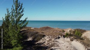 Aerial view flying around Pinery provincial park Ontario, Canada coastal sandy woodland shoreline looking across lake Huron