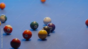 Billiard break shot. Colourful pool balls with cue on billiards table for start to play. Billiard balls with numbers on a pool table. Team sport. (4K close up)