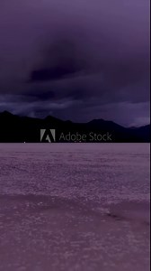 Uyuni Salt Flats. Salar De Uyuni. Aerial View. Altiplano, Bolivia. Rainy Season. Dramatic and Stormy Sky. Drone Flies Forward at Low Level. Wide Shot. Vertical Video