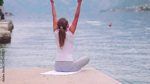 Beautiful yoga with amazing view of sea on background, pretty healthy woman with perfect body stand in one of yoga pose Stock Video
