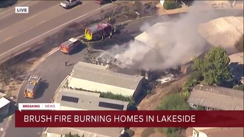 Brush fire burning homes in Lakeside