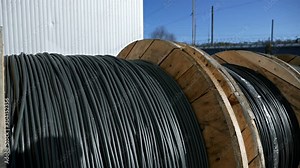 Close-up of a power cable on a big wooden spool. Finished products cable plant