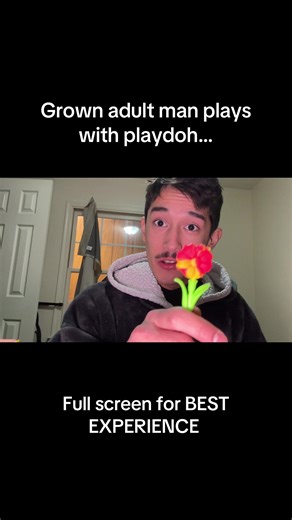Grown man plays with play doh
