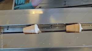 Modern ice cream automated production line. Advanced technology, equipment at milky, dairy foor production plant. Desserts on conveyor belt. Manufacture process. Ice cream factory, close up