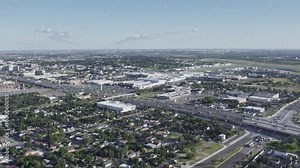 SUNNY DAY DRONE FLY OVER MCALLEN DOWNTOWN FACING SOUTH-EAST, LOCAL MALL, EXPRESSWAY, AIRPORT AND MEDICAL ZONE AT THE HORIZONT