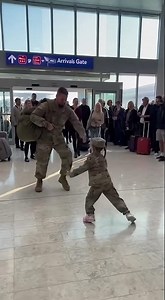 A discharged soldier hugs his child who came to pick him up