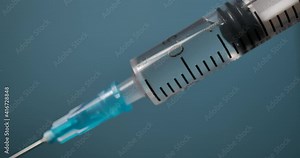 Close Up of Injection Liquid Being In Syringe Against Red Background. Medication Drug Needle Syringe Drug, Flu Shot Vaccine Vial Dose Hypodermic Injection Treatment Disease Prevention Immunization.