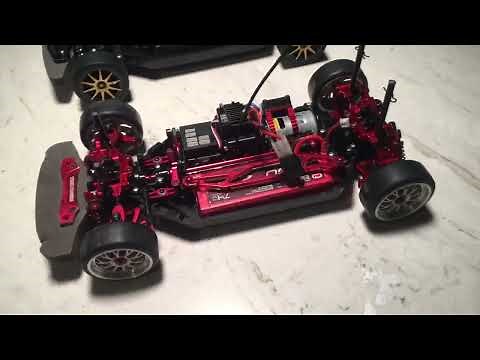 Rc Car | Yeah Racing Tamiya TT-02 (Red) Aluminum Upgrade Kit next to Stock rolling chassis