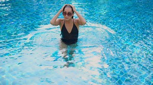 vecteezy_beautiful-woman-around-swimming-pool_2132936