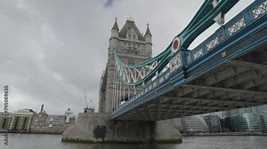 London, United Kingdom - People crossing the Tower Bridge bascule and suspension bridge over River Thames