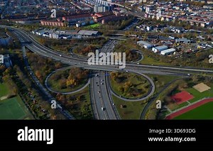 Complex highway interchange with cars traversing roads in an aerial view of Berlin. static tripod hovering drone
